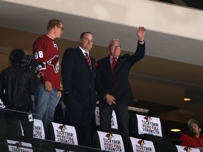 Anthony LeBlanc (centre) and W. R. Dutton (right) wave to fans during an NHL game April 13, 2014 in Glendale, Arizona. (AFP Files)