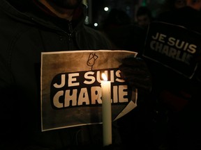 A candlelight vigil is held in front of the French Consulate in Toronto on Jan. 7, 2015. (Stan Behal/Toronto Sun)