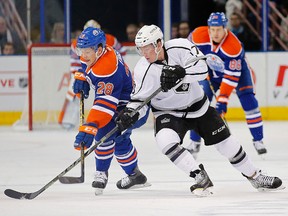 Edmonton Oilers forward Matt Fraser (28) and Los Angeles Kings forward Tyler Toffoli (73) battle for a loose puck during the second period at Rexall Place on Dec 30, 2014. Perry Nelson-USA TODAY Sports