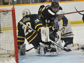 Laurentian Voyageurs' Gary Horic tries to shovel in a loose puck past Lancers' goalie Parker Van Buskirk during OUA men's hockey action at Gerry McCrory Countryside Sports Complex on Saturday. The Voyageurs lost 4-1.