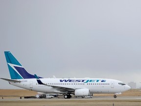 A Westjet Boeing 737-700 takes off at the International Airport in Calgary, Alberta, in this file photo taken  May 3, 2011. WestJet Airlines Ltd, Canada's No. 2 carrier, reported a 16 percent rise in quarterly earnings, helped by a 5.5 percent rise in revenue passenger miles, July 29, 2014. REUTERS/Todd Korol/Files