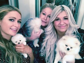Socialite Paris Hilton (Left) recently paid Calgary dog breeder Joanne Pedram (Right) $25,000 for two teacup Pomeranians, one of which as a gift for her mother Kathy (Centre, holding her new pet) for her 35th wedding anniversary. Pedram personally delivered the two dogs to Hilton herself last week. Provided photo.