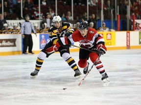 Ottawa 67's forward Ben Fanjoy gets held up by the Kingston Frontenac's Jake Gilmour during during the first period of Sunday's game at TD Place. (Chris Hofley/Ottawa Sun)