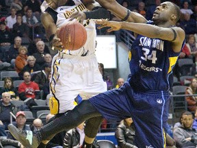 Emmanuel Little of the London Lightning is fouled by Tyrone Levett of the Saint John Mill Rats during their National Basketball League of Canada game at Budweiser Gardens Sunday. The Mill Rats won 122-109. (DEREK RUTTAN, The London Free Press)