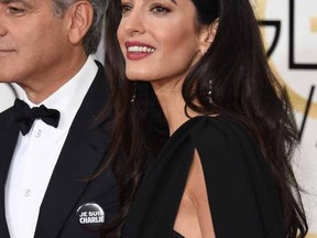 George Clooney and Amal Clooney. 

AFP PHOTO / MARK RALSTON