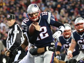 Patriots QB Tom Brady runs in for a touchdown against the Ravens on Saturday afternoon. (AFP)