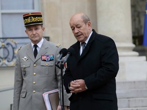 French Defence Minister Jean-Yves Le Drian (R) stands beside French Army Chief of Staff General Pierre Le Jolis de Villiers de Saintignon as they speak to journalists after a crisis meeting at the Elysee Palace in Paris, Jan. 12, 2015.     REUTERS/Philippe Wojazer