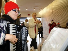 Antonina Durham cheers on Jessica Melchiorre as she plays traditional European tunes during Russian New Year and Russian Orthodox Christmas celebrations at Bay View Mall on Saturday. JASON MILLER/THE INTELLIGENCER