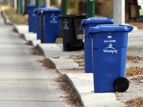 Recycling and garbage carts damaged by third parties may be replaced at no cost to homeowners, if a new policy is passed by city council later this month. (BRIAN DONOGH/WINNIPEG SUN FILE PHOTO)