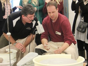 Observer reporter Tyler Kula listens to tips from Inn of the Good Shepherd Executive Director Myles Vanni as he crafts a clay bowl at Lambton College. Kula and Vanni were two of about 20 community "celebrities" creating clay vessels to be part of the annual Empty Bowls fundraiser in February. (SUBMITTED PHOTO)