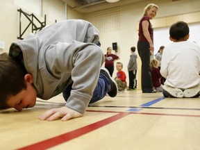 Emily Mountney-Lessard/The Intelligencer
Students at Tweed Elementary School use their noses to push quarters to their teammates during a fun competition held at the school Monday. The race was part of the kickoff of the school's campaign to raise money for the Emily Trudeau Splash Pad.