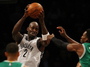 Nets forward Kevin Garnett (left) was ejected Monday night after headbutting Rockets centre Dwight Howard during NBA action in New York. (Noah K. Murray/USA TODAY Sports/Files)