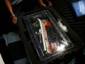 The flight data recorder from AirAsia QZ8501 is placed into a container at the National Transportation Safety Committee office in Jakarta January 12, 2015. REUTERS/Beawiharta