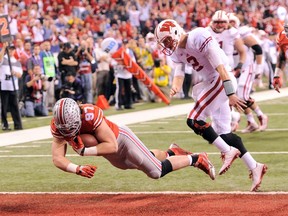 Ohio State Buckeyes linebacker Joey Bosa (97) dives in the end zone to score a touchdown after recovering a fumble against the Wisconsin Badgers in the Big Ten football championship game at Lucas Oil Stadium. Thomas J. Russo-USA TODAY Sports