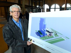 Slavko Prtenjaca of Creative Property Developments shows a rendering of a proposed 25-storey tower that could be built on the block bounded by Bathurst, Waterloo and Horton streets. (MORRIS LAMONT, The London Free Press)