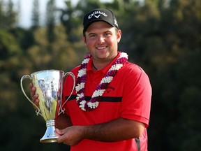 Patrick Reed poses with the trophy after beating Jimmy Walker in a playoff at the Tournament of Champions at Plantation Course at Kapalua Golf Club in Lahaina, Hawaii, yesterday. (AFP)