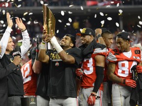 Ohio State Buckeyes running back Ezekiel Elliott (15) celebrates with the college football playoff trophy after beating the Oregon Ducks in the 2015 CFP National Championship Game at AT&T Stadium. Mandatory Credit: Tommy Gilligan-USA TODAY Sports