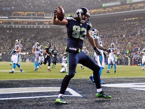 Luke Willson #82 of the Seattle Seahawks celebrates after scoring a 25-yard touchdown in the fourth quarter against the Carolina Panthers during the 2015 NFC Divisional Playoff game at CenturyLink Field on January 10, 2015 in Seattle, Washington. (Steve Dykes/Getty Images/AFP)