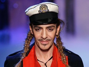 British designer John Galliano appears at the end of his Spring/Summer 2011 women's collection during Paris Fashion Week in this October 1, 2010 file photo. Fashion brand Maison Martin Margiela has hired ex-Christian Dior star designer Galliano as its new creative director, its parent group Only the Brave, owner of jeans brand Diesel, said on October 6, 2014. Galliano, one of the most flamboyant and successful designers in the fashion industry, was sacked in 2011 by LVMH, parent of Dior and his eponymous brand, after a video showed him making anti-semitic comments in a Paris bar. (REUTERS/Benoit Tessier/Files)