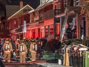 Firefighters at the scene of a fire and explosion at 79 Markham St., near Queen and Bathurst Sts., Shortly before midnight Monday, Jan. 12, 2015.