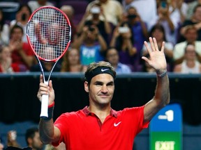 Switzerland's Roger Federer celebrates after winning his match against Australia's Lleyton Hewitt for the launch of a new format of tennis called 'Fast4' at the Entertainment Center in Sydney January 12, 2015.  REUTERS/Rick Stevens