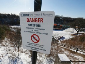A sign in Toronto's Sir Winston Churchill Park alerts people about a prohibition on skiing, tobogganing, and sledding. (STAN BEHAL, Toronto Sun)
