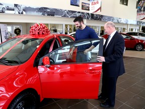 Chris Laking, right, owner of Laking Toyota in Sudbury, ON., shows Darren Lamoureux, of Chelmsford, a new Toyota Corolla he and his wife, Desiree, won by participating in a contest. The Lamoureux's received $25,000 and the new car, as part of the Ontario Toyota Dealers Association Holiday Wishmaker Campaign. JOHN LAPPA/THE SUDBURY STAR/QMI AGENCY