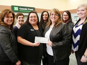Emily Mountney-Lessard/The Intelligencer
Michelle Brown, manager of customer service at the Madoc branch of TD Canada Trust, hands a $4,500 cheque to Food for Learning coordinator Kellie Brace at the bank Tuesday. Also shown are (from left) Annette Baker, branch manager; Patti Marlin representing Centre Hastings Secondary School; Charmaine Hewitt, representing Madoc Public School; Valerie Montgomery, representing Marmora Senior School and Earl Prentice Public School and Vicky VanRoie, Food for Learning community development co-ordinator.