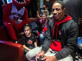 Cole Guimond,8, plays a game with DeMar DeRozan during the Raptors visit to SickKids Hospital yesterday. (Dave Abel/Toronto Sun)