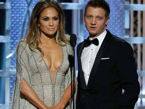 Actors Jennifer Lopez (L) and Jeremy Renner present at the 72nd Golden Globe Awards in Beverly Hills, California January 11, 2015.  REUTERS/Paul Drinkwater/NBC/Handout