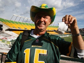 Chris Cross, a 40-year fan, buys his 50/50 tickets before a CFL football game between the Edmonton Eskimos and the Calgary Stampeders at Commonwealth Stadium.
