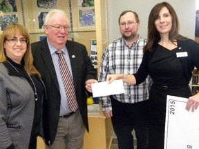 Mayor Jim Harrison and city finance director David Clazie present Prince Edward and Hastings Learning Foundation executive director Meribeth deSnoo and Food for Learning program coordinator Kelli Brace with a $5,922 cheque Jan. 14, 2015. The money was raised during the sixth annual Feed the Meter campaign. Ernst Kuglin/The Intelligencer/QMI Agency