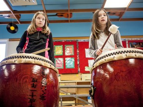 From left, Tianna Porsnuk and Charlie Petrovic, both Grade. 5 students at Whitecourt Central Schoo,l learn to keep rythem with a set of Japanese Taiko Drums during a music class on Thursday January 8, 2015 in Whitecourt, Alta. The drums were donated to the Whitecourt by their sister city of Yubetsu, which is in Hokkaido, Japan. 
Adam Dietrich | Whitecourt Star