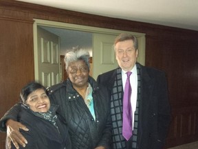 A photo tweeted by Toronto Mayor John Tory's Twitter account show him posing with two residents of a Pharmacy Ave. highrise around 6:30 a.n. on Jan. 14, 2015. (Twitter photo)