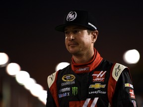 Kurt Busch, driver of the #41 Haas Automation Chevrolet, stands on the grid during qualifying for the NASCAR Sprint Cup Series Ford EcoBoost 400 at Homestead-Miami Speedway on November 14, 2014 in Homestead, Florida. (Patrick Smith/Getty Images/AFP)