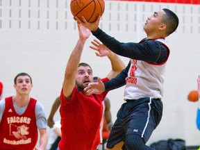 Falcons guard Ernest Tolete drives to the hoop while Kyle McConnell plays defence during a practice this week at Fanshawe. The Falcons are preparing for a big game Sunday against Lambton Lions at Budweiser Gardens prior to the London Lightning?s game. (Mike Hensen, The London Free Press)
