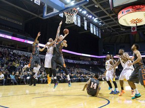 London Lightning player Jonathan Mills is blocked by Moncton Miracles player Jason Conrad during their NBL Canada basketball game at Budweiser Gardens in London. (Free Press file photo)