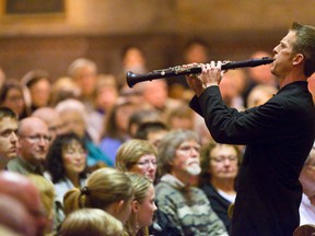Members of the audience watch as principal clarinet player Graham Lord plays Mozart's Clarinet Concerto in A major at Metropolitan United Church in London, Ontario on Wednesday. CRAIG GLOVER/The London Free Press/QMI Agency