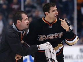 Anaheim Ducks' Andrew Cogliano points to his mouth as he looks for a call from the referee after taking a stick to the face from Chicago Blackhawks' Brandon Bollig during the third period of their NHL hockey game in Anaheim, Calif., on March 20, 2013. (DANNY MOLOSHOK/Reuters)