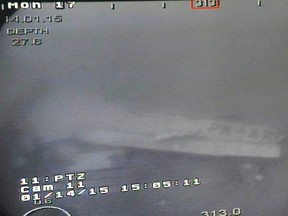A part of the wing of the AirAsia Flight QZ8501 is seen in an image captured by the Remotely Operated Vehicle (ROV) on the Singapore Navy's MV Swift Rescue, in the Java Sea on January 14, 2015. Indonesian navy divers searched for bodies on Thursday in the fuselage of the AirAsia airliner that crashed into the sea more than two weeks ago, killing all 162 people on board. A military vessel found the fuselage on Wednesday, about 3 km (2 miles) from where the tail of the aircraft was hauled up from the bottom of the Java Sea last weekend. REUTERS/Handout via Singapore's Ministry of Defence (MINDEF)