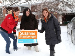 JOHN LAPPA/THE SUDBURY STAR
Sudbury NDP candidate Suzanne Shawbonquit, right, places a sign on an NDP supporter's yard in New Sudbury on Wednesday with the help of her daughter, Sindy, left, and her sister, Nikki Moore.