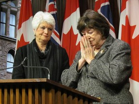 Margaret Wilson, right, becomes emotional as she describes Toronto District School Board staff in tears as they told her about the culture of fear in the organization, as Ontario Education Minister Liz Sandals, left, issued a number of directions to the TDSB on Thursday January 15 2014 in response to concerns raised in Wilson's report. (Toronto Sun/Antonella Artuso)