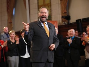NDP leader Thomas Mulcair receives a standing ovation while delivering a speech to his caucus on Parliament Hill in Ottawa, Jan. 15, 2015. (CHRIS WATTIE/Reuters)