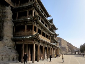 A wooden facade at the extensive Yungang Grottoes at Datong, China. The complex includes 45 caves and about 200 niches with more than 51,000 carvings. IAN ROBERTSON PHOTO