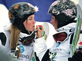 Canada's Justine Dufour-Lapointe, left, gets a little lip balm application from here sister Chloe Dufour-Lapointe at the FIS Freestyle World Cup ski event at Canada Olympic Park in Calgary, Alberta, on  Friday January 2, 2015. (Mike Drew/Calgary Sun/QMI AGENCY)