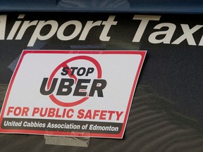 Taxi drivers surround Edmonton City Hall during an anti-Uber protest, in Edmonton Alta., on Wednesday Jan. 15, 2015. David Bloom/Edmonton Sun