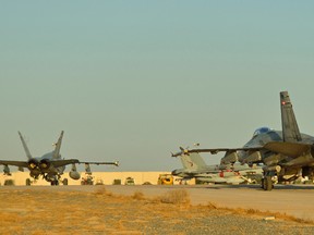 Royal Canadian Air Force CF-18 Fighter jets from 4 Wing Cold Lake, Alberta taxi to the Canadian Air Task Force-Iraq ramp in Kuwait after dropping bombs on targets in Iraq during Operation IMPACT on November 3, 2014. Photo: Canadian Forces Combat Camera, DND