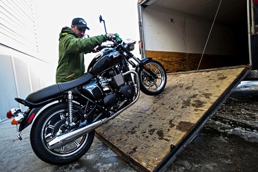 Josh Goguen of Echo Cycle unloads a Triumph motorcycle during set up for the 2015 Motorcycle and ATV Show in Edmonton, Alta., on Wednesday, Jan. 14, 2015. Codie McLachlan/Edmonton Sun/QMI Agency