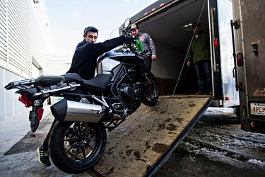Dave Boire of Echo Cycle unloads a Triumph motorcycle during set up for the 2015 Motorcycle and ATV Show in Edmonton, Alta., on Wednesday, Jan. 14, 2015. Codie McLachlan/Edmonton Sun/QMI Agency