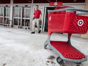 A Target store manager walks to collect a stray shopping cart outside of an Ottawa location that is slated to close along with all other Canadian Target stores. January 15, 2015. (Errol McGihon/Ottawa Sun/QMI Agency)
